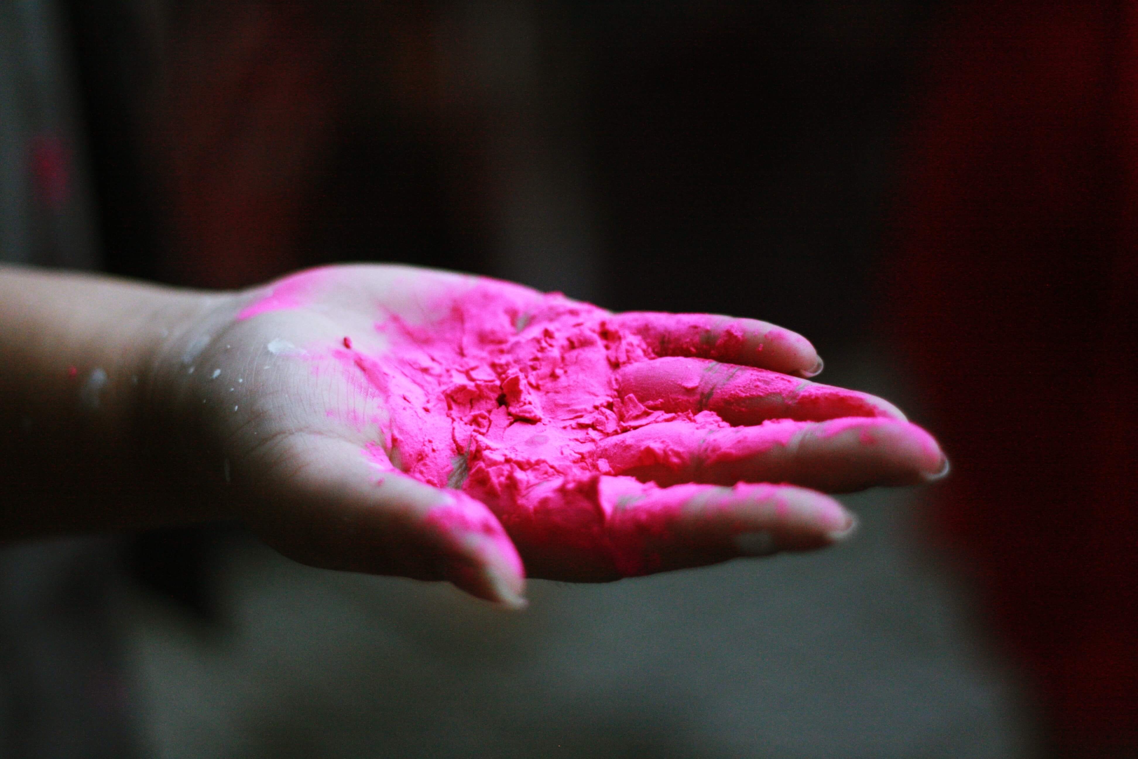 hand with pink paint powder